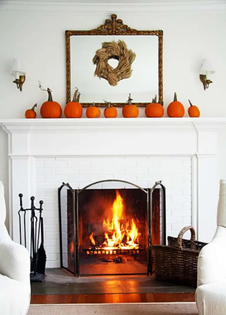 White fireplace decorated with pumpkins